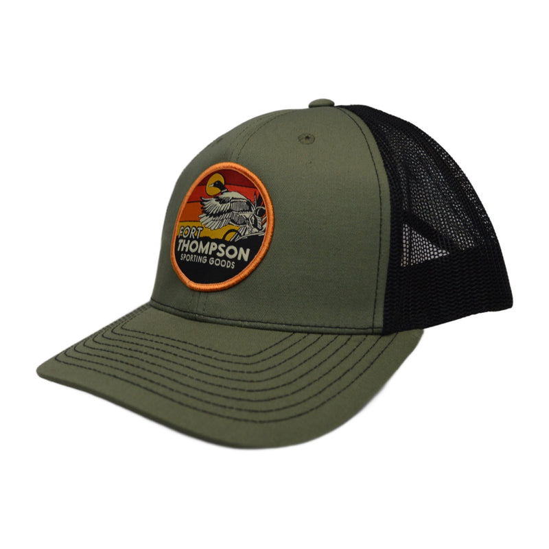 Load image into Gallery viewer, Side view of Fort Thompson Retro Circle Patch Cap in the color Loden/Black.
