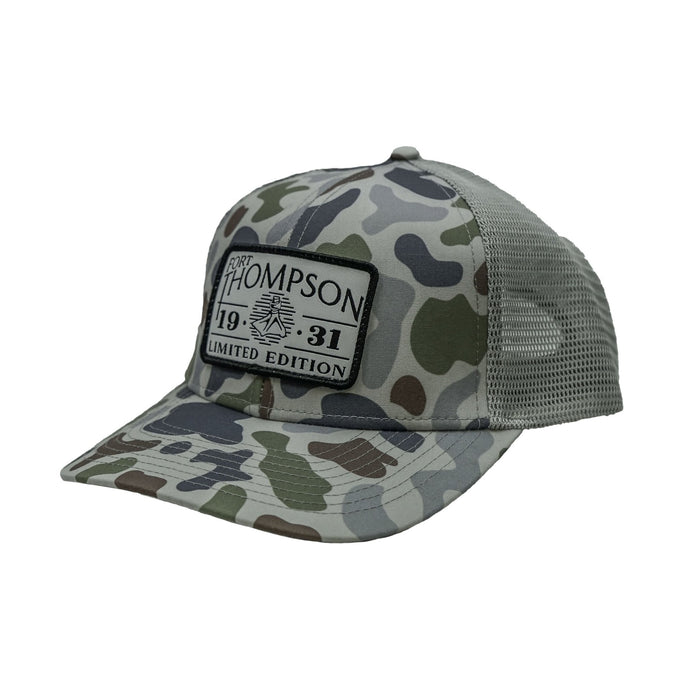 Fort Thompson White Rectangle Patch Trucker Style Hat in the color Brackish Smoke with a rectangle patch that says 