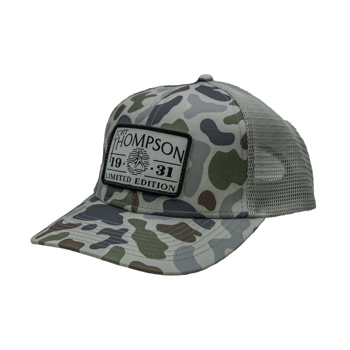 Fort Thompson White Rectangle Patch Trucker Style Hat in the color Brackish Smoke with a rectangle patch that says 