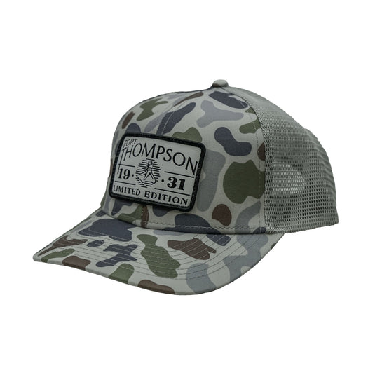 Fort Thompson White Rectangle Patch Trucker Style Hat in the color Brackish Smoke with a rectangle patch that says "Fort Thompson 1931 Limited Edition" on the center of the hat.