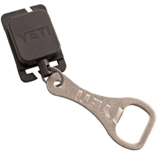 The YETI Molle Zinger is shown attached to a YETI Hopper HitchPoint Grid with a multitool and bottle opener hanging from it.